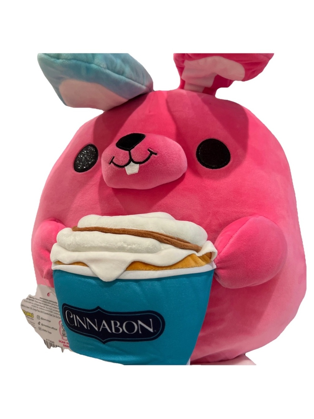 SNACKLES 14” Pink Bunny Super Plush Toy holding a Cinnabon Cinnamon Roll By Zuru